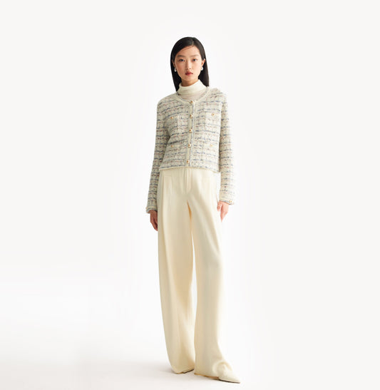 White female tweed jacket with crewneck, four front pockets, velvet metal logo buttons, and buttoned sleeve vents. White female tweed jacket with crewneck, four front pockets, velvet metal logo buttons, and buttoned sleeve vents. front-view.