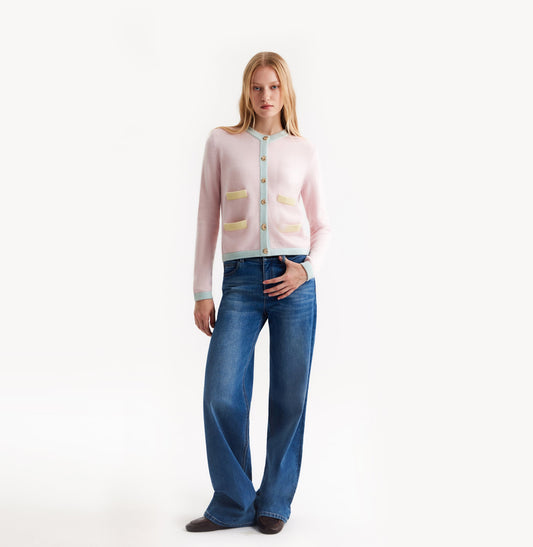 Light pink cashmere cardigan with baby blue and pale yellow contrast trims and shoulder pads. front-view