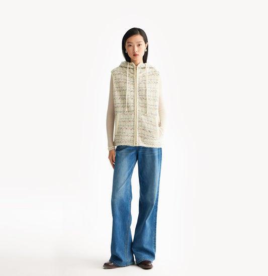 White womens tweed vest with relaxed fit hooded design metallic ring zip high collar and adjustable drawstring hem. White womens tweed vest with relaxed fit hooded design metallic ring zip high collar and adjustable drawstring hem. front-view.