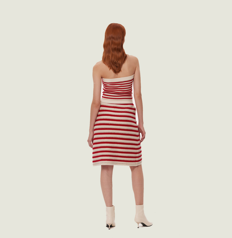 Wool long skirt with slit in red and white jacquard stripes. rear-view