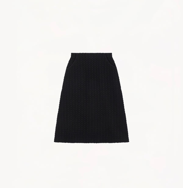 Black A line midi skirt with embossed jacquard texture built in side pockets and structured waist hem details.