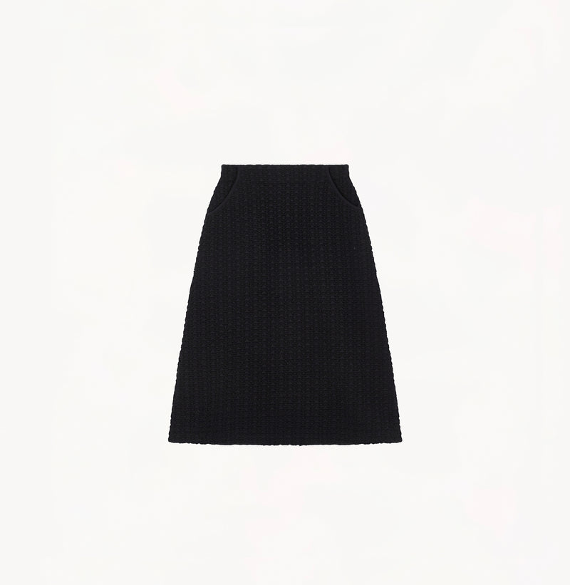 Black A line midi skirt with embossed jacquard texture built in side pockets and structured waist hem details.
