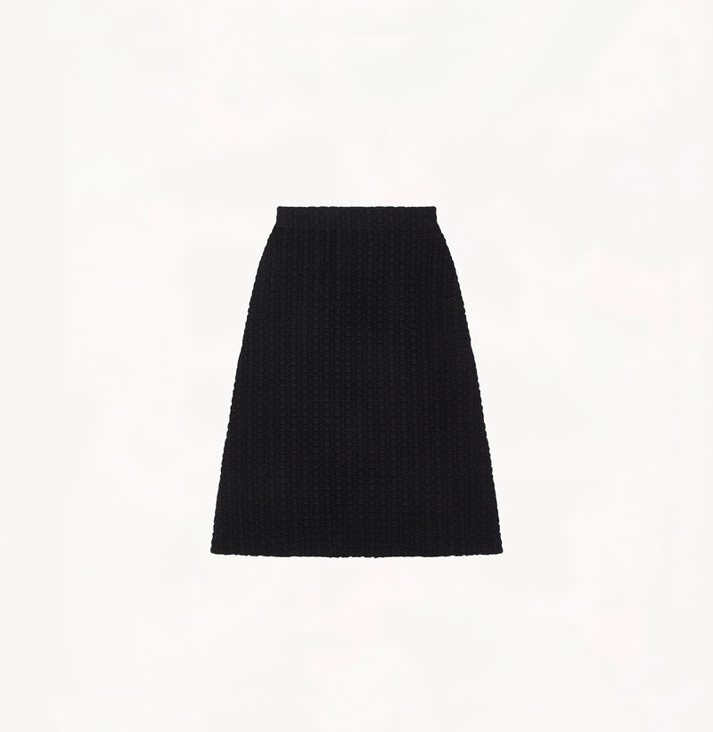 Black A line midi skirt with embossed jacquard texture built in side pockets and structured waist hem details.