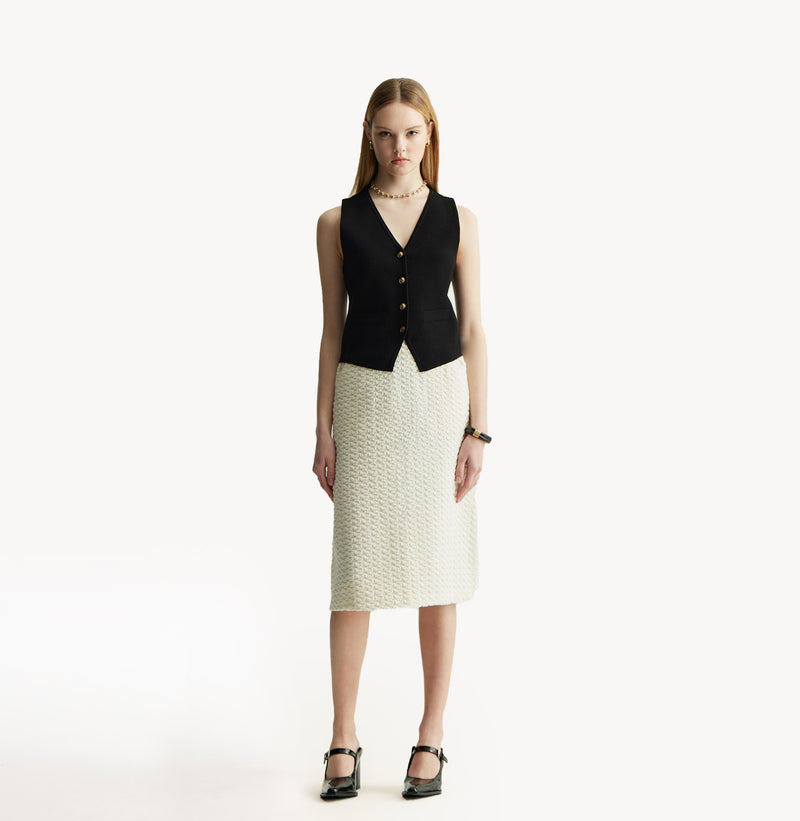 White A line midi skirt with embossed jacquard texture built in side pockets and structured waist hem details.