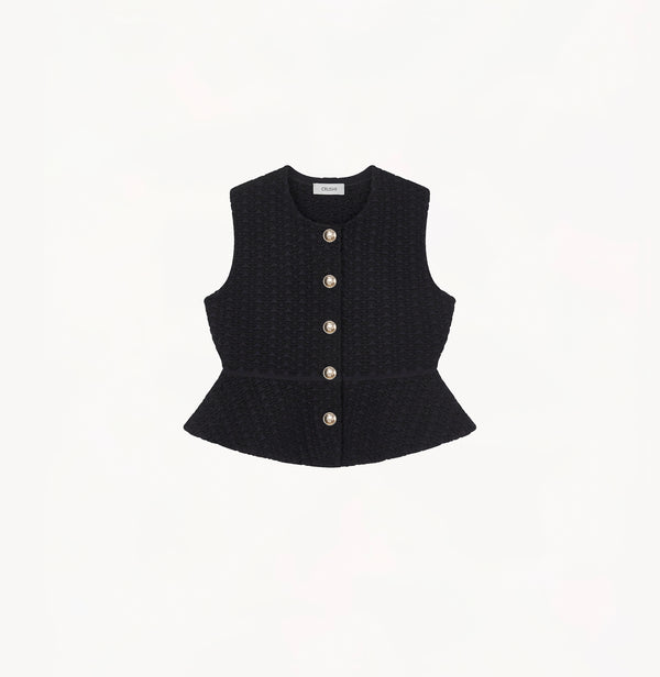 Black womens fitted vest in wool blend stretch fabric with cinched waist flared hem and seamless edge trim.