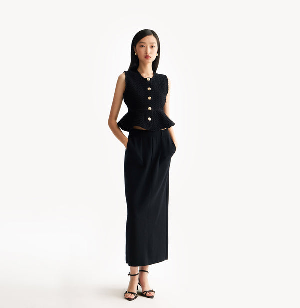 Black womens fitted vest in wool blend stretch fabric with cinched waist flared hem and seamless edge trim. front-view.