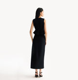 Black womens fitted vest in wool blend stretch fabric with cinched waist flared hem and seamless edge trim. rear-view.