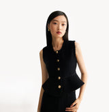 Black womens fitted vest in wool blend stretch fabric with cinched waist flared hem and seamless edge trim. left-view.