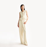 White womens fitted vest in wool blend stretch fabric with cinched waist flared hem and seamless edge trim.