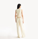 White womens fitted vest in wool blend stretch fabric with cinched waist flared hem and seamless edge trim.
