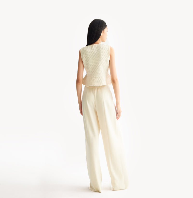 White womens fitted vest in wool blend stretch fabric with cinched waist flared hem and seamless edge trim.