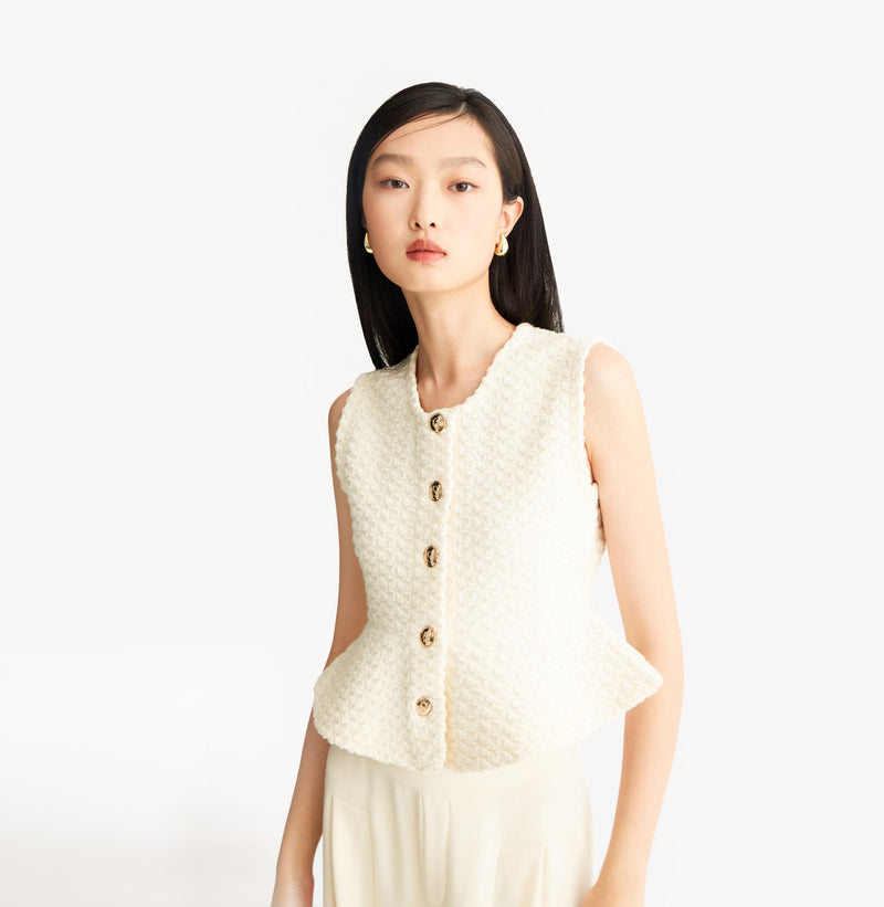 White womens fitted vest in wool blend stretch fabric with cinched waist flared hem and seamless edge trim.