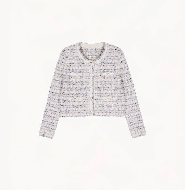 White female tweed jacket with crewneck, four front pockets, velvet metal logo buttons, and buttoned sleeve vents.