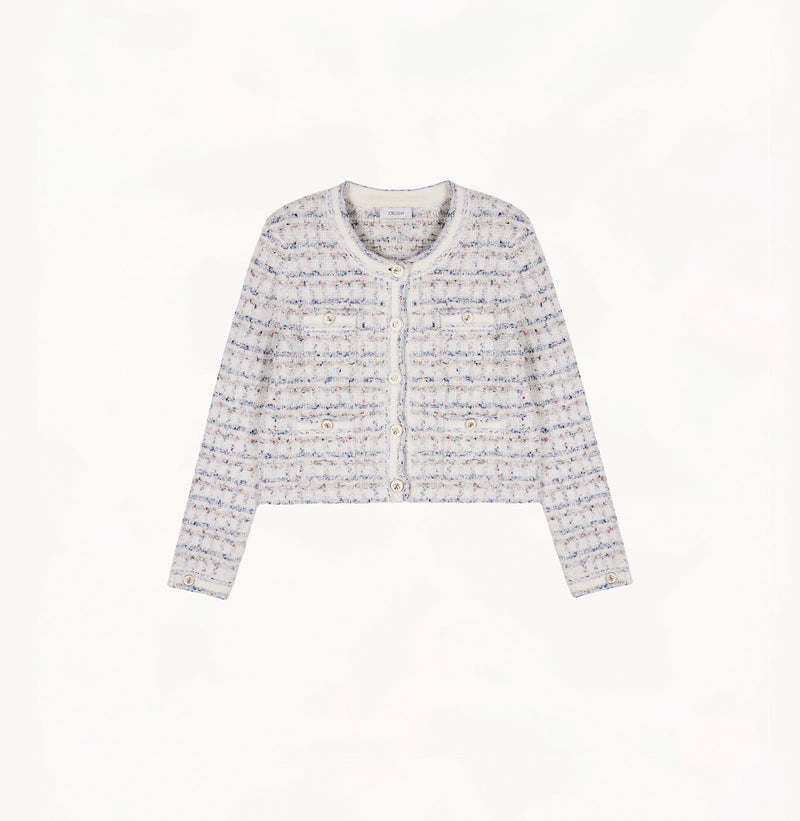 White female tweed jacket with crewneck, four front pockets, velvet metal logo buttons, and buttoned sleeve vents.