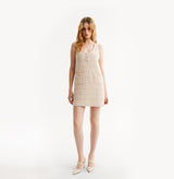 Woman wearing a pink sleeveless dress on a white background, front-view