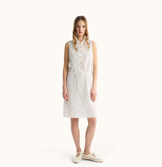 Woman wearing a white sleeveless dress on a white background, front view