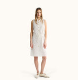 Woman wearing a white sleeveless dress on a white background, front view