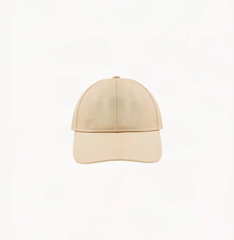 Beige baseball cap in cotton twill with embroidered monogram logo and classic beige tones.