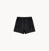 Black sheepskin shorts with relaxed pleated design and elastic waistband.