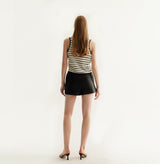 Black sheepskin shorts with relaxed pleated design and elastic waistband.