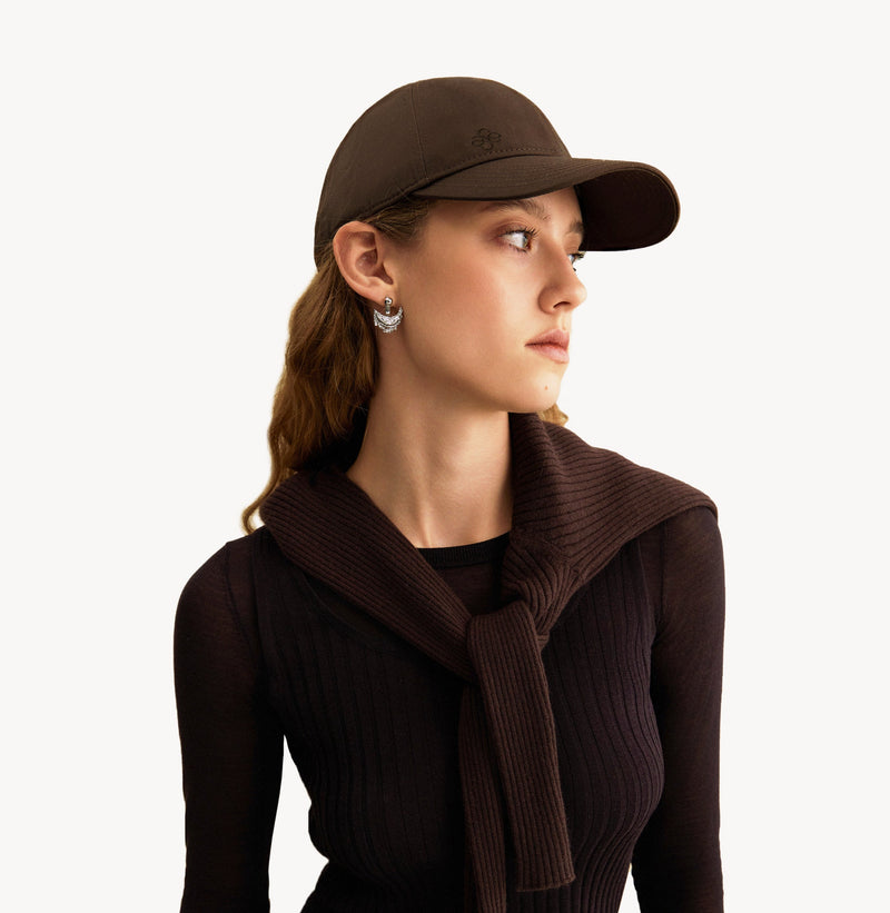 Brown baseball cap in cotton twill with embroidered monogram logo and classic coffee tones. front-view.