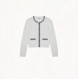 White colorblock cotton cardigan with fitted silhouette, crewneck, contrasting trim details, and decorative metal buttons.