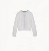 White colorblock cotton cardigan with fitted silhouette, crewneck, contrasting trim details, and decorative metal buttons.