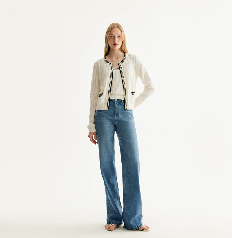 White colorblock cotton cardigan with fitted silhouette, crewneck, contrasting trim details, and decorative metal buttons. front-view
