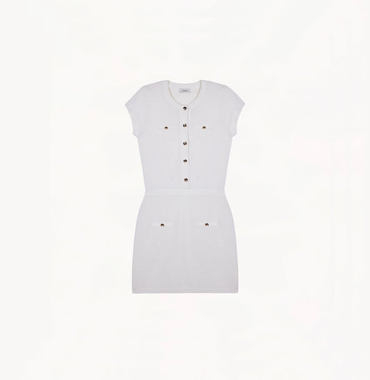 White silk-cotton dress with fitted silhouette, cap sleeves, and decorative front pockets.