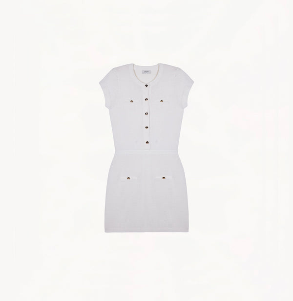 White silk-cotton dress with fitted silhouette, cap sleeves, and decorative front pockets.