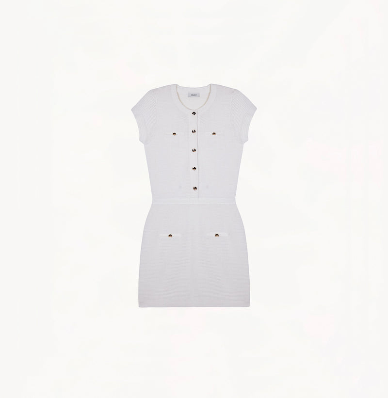 White silk-cotton dress with fitted silhouette, cap sleeves, and decorative front pockets.