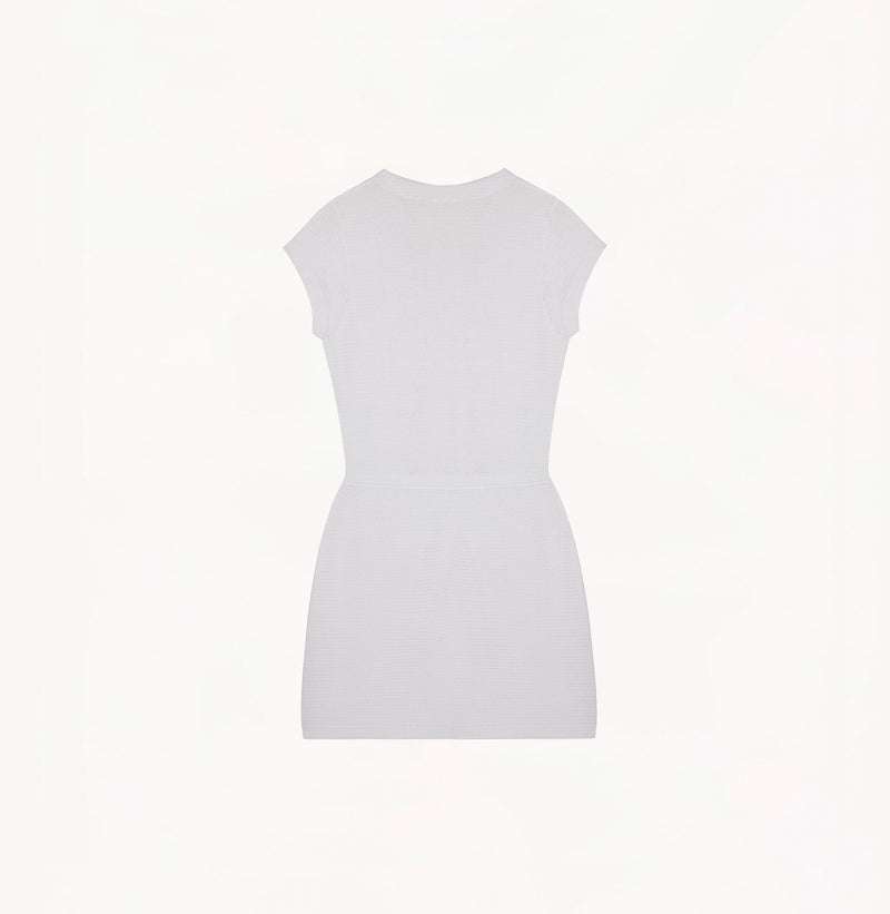 White silk-cotton dress with fitted silhouette, cap sleeves, and decorative front pockets.