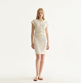 White silk-cotton dress with fitted silhouette, cap sleeves, and decorative front pockets. front-view