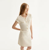 White silk-cotton dress with fitted silhouette, cap sleeves, and decorative front pockets. left-view