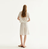 White cotton-linen diamond pointelle shirt with metallic trim and Polo collar. rear-view