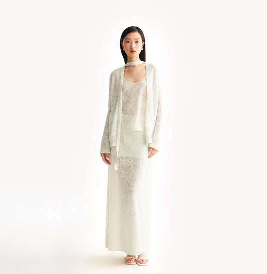 White relaxed fit lace cardigan with shimmering sequin yarn, pointelle trim, and ribbon neckline.  front-view