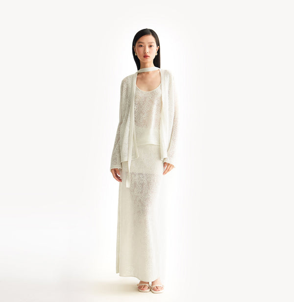 White relaxed fit lace cardigan with shimmering sequin yarn, pointelle trim, and ribbon neckline.  front-view