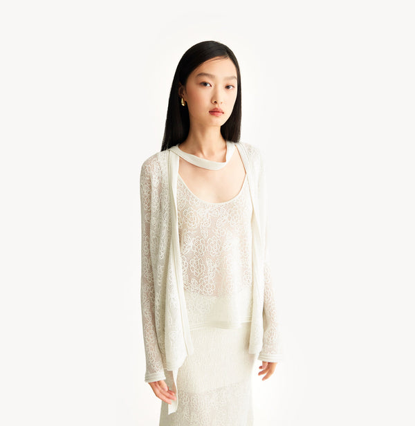 White relaxed fit lace cardigan with shimmering sequin yarn, pointelle trim, and ribbon neckline. left-view