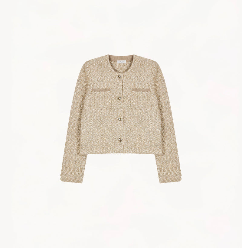 Beige ladies cropped boucle jacket in cashmere blend with shoulder padding, folded edges, and double-layered pocket flaps. 
