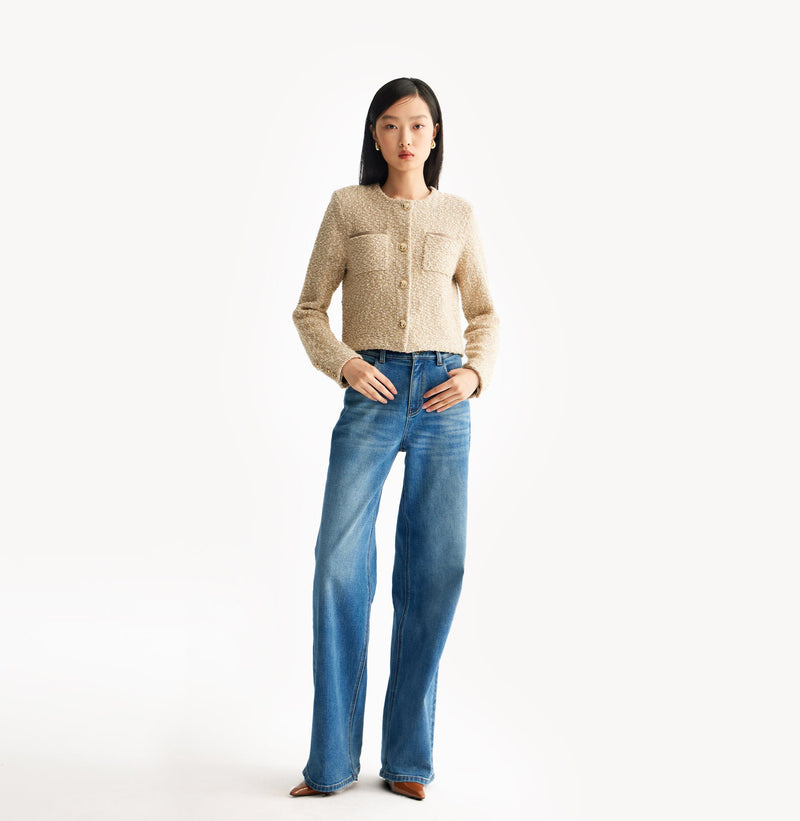 Beige ladies cropped boucle jacket in cashmere blend with shoulder padding, folded edges, and double-layered pocket flaps. 