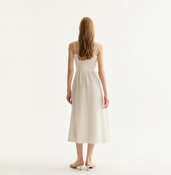 Chinese-inspired lily floral dress with cinched waist and gathered pleats in white. rear-view