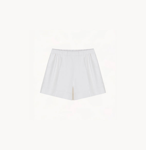 White sheepskin shorts with relaxed pleated design and elastic waistband.