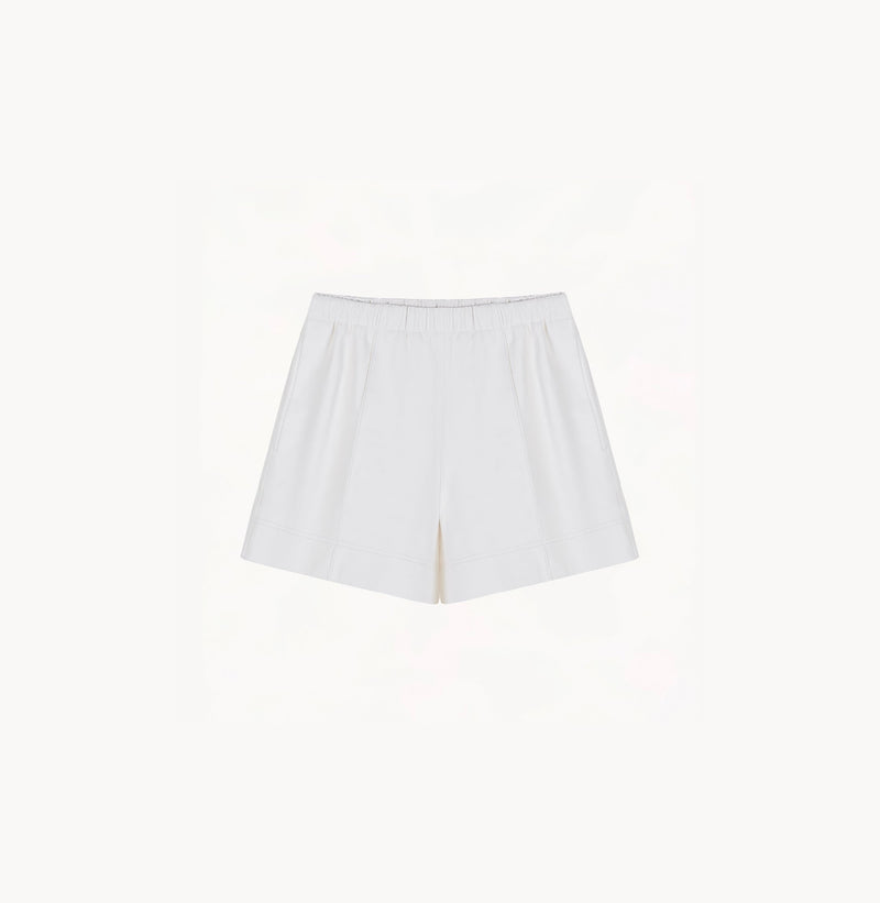 White sheepskin shorts with relaxed pleated design and elastic waistband.