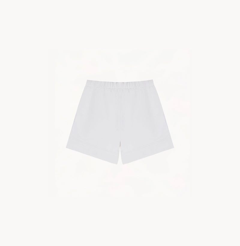 White sheepskin shorts with relaxed pleated design and elastic waistband.