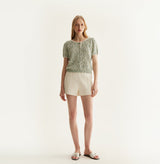 White sheepskin shorts with relaxed pleated design and elastic waistband. front-view