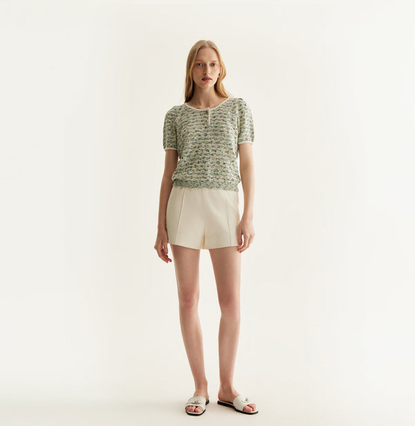 White sheepskin shorts with relaxed pleated design and elastic waistband. front-view