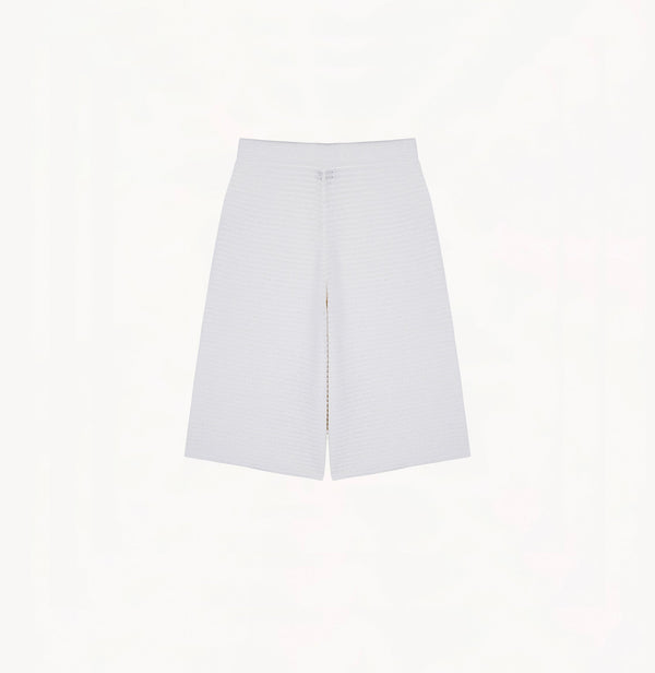 White cotton-linen shorts with relaxed wide-leg cut, petal trims, and pointelle waistband.