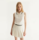 White cotton pleated mini skirt with loose flared silhouette and contrasting trim waistband. left-view