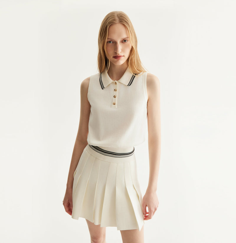 White cotton pleated mini skirt with loose flared silhouette and contrasting trim waistband. left-view