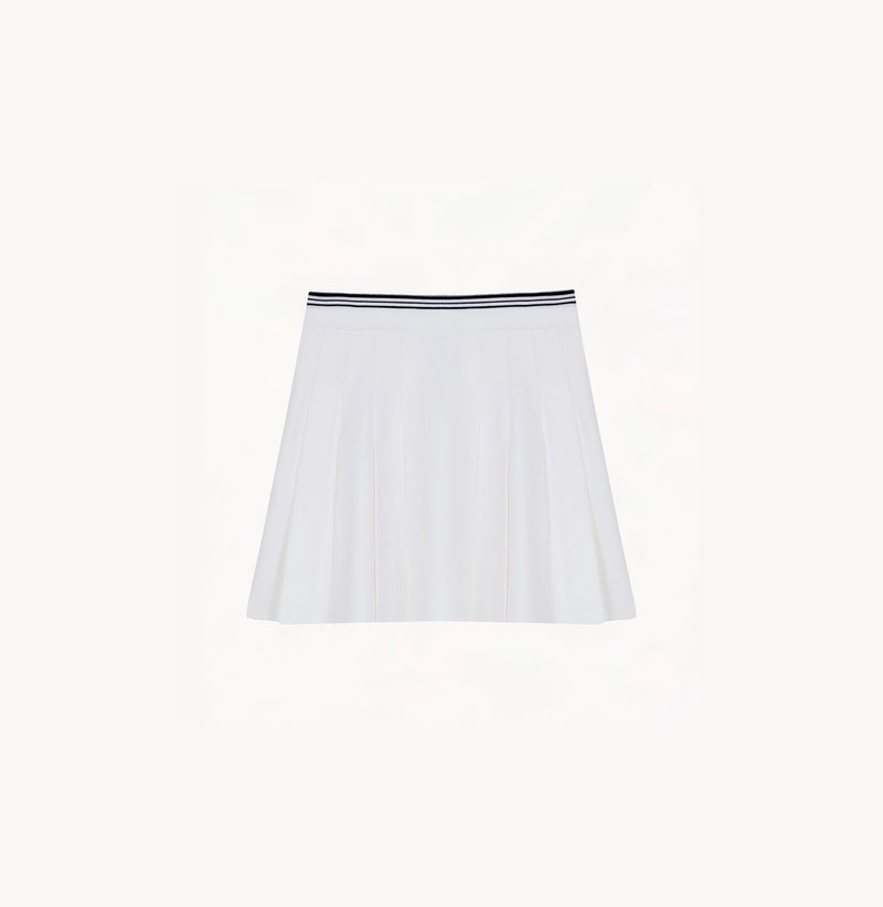 White cotton pleated mini skirt with loose flared silhouette and contrasting trim waistband.